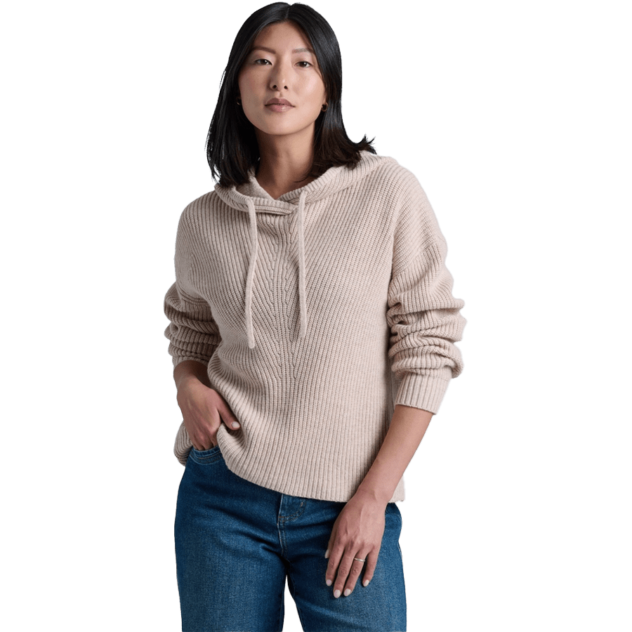 Women's beige ribbed knit hoodie sweater with drawstring and blue jeans