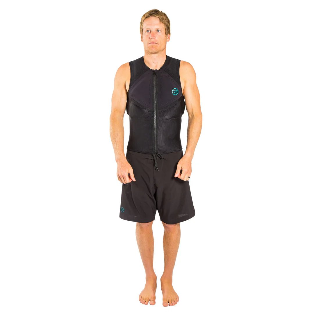 Man wearing black sleeveless zip-up impact vest and black board shorts, studio background