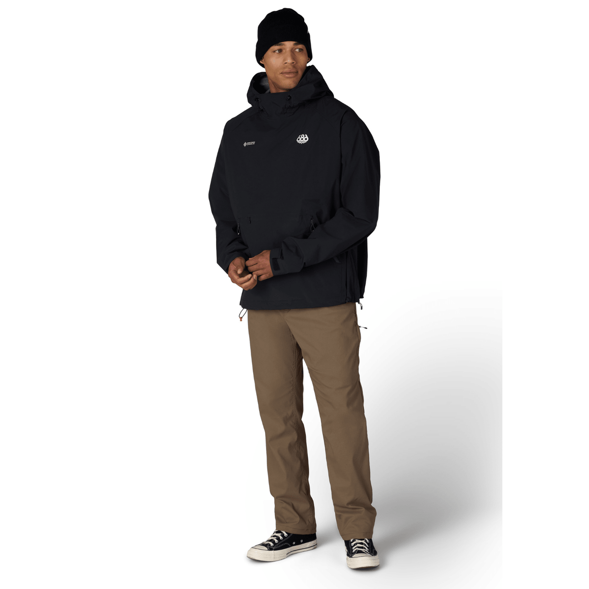 686 men's pullover hoody with hood, chest logo patch, and drawcord hem on model