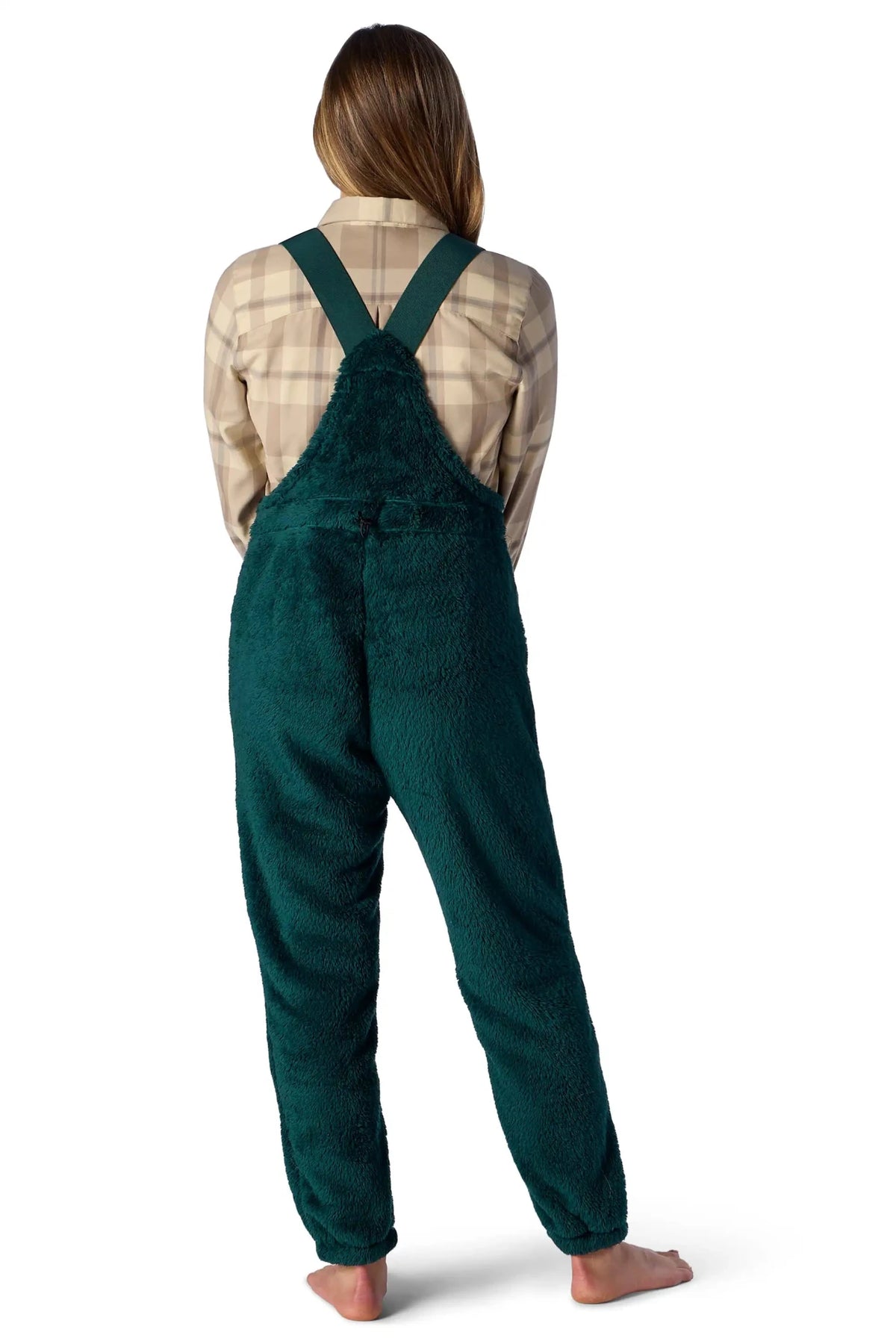 Women's sherpa fleece bib overall with crossed back straps, worn over plaid shirt.