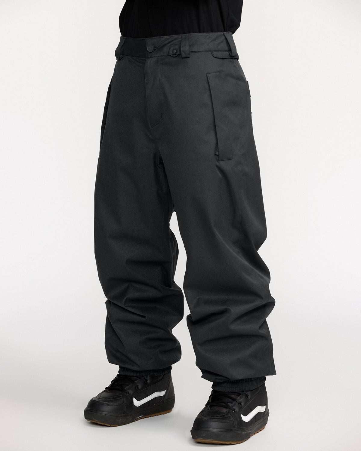 Volcom men's black shell snow pants with relaxed fit and Vans snowboard boots