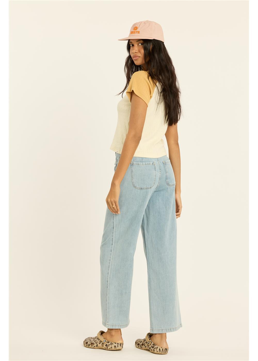 Women's short-sleeve colorblock knit crop top with contrast sleeves, shown from back