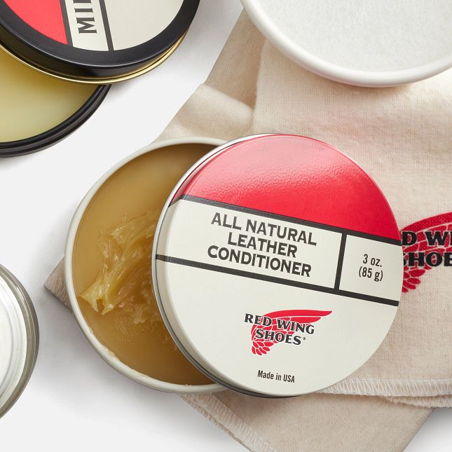 Red Wing Shoes all natural leather conditioner tin on cloth, open container showing balm
