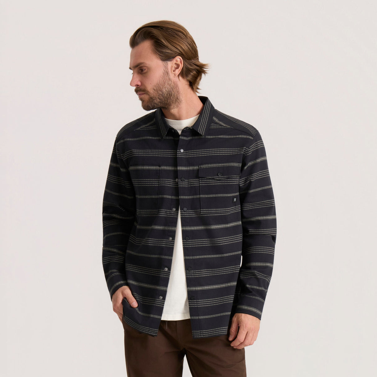 Men's long sleeve striped button-up shirt with dual chest pockets and snap closures