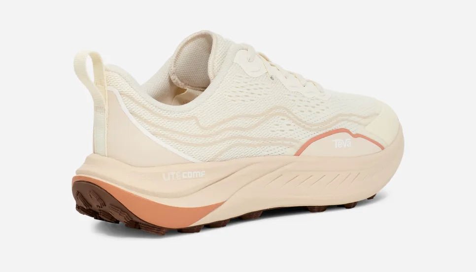 Women's beige and peach low hiking shoe with mesh upper and rugged sole on white background
