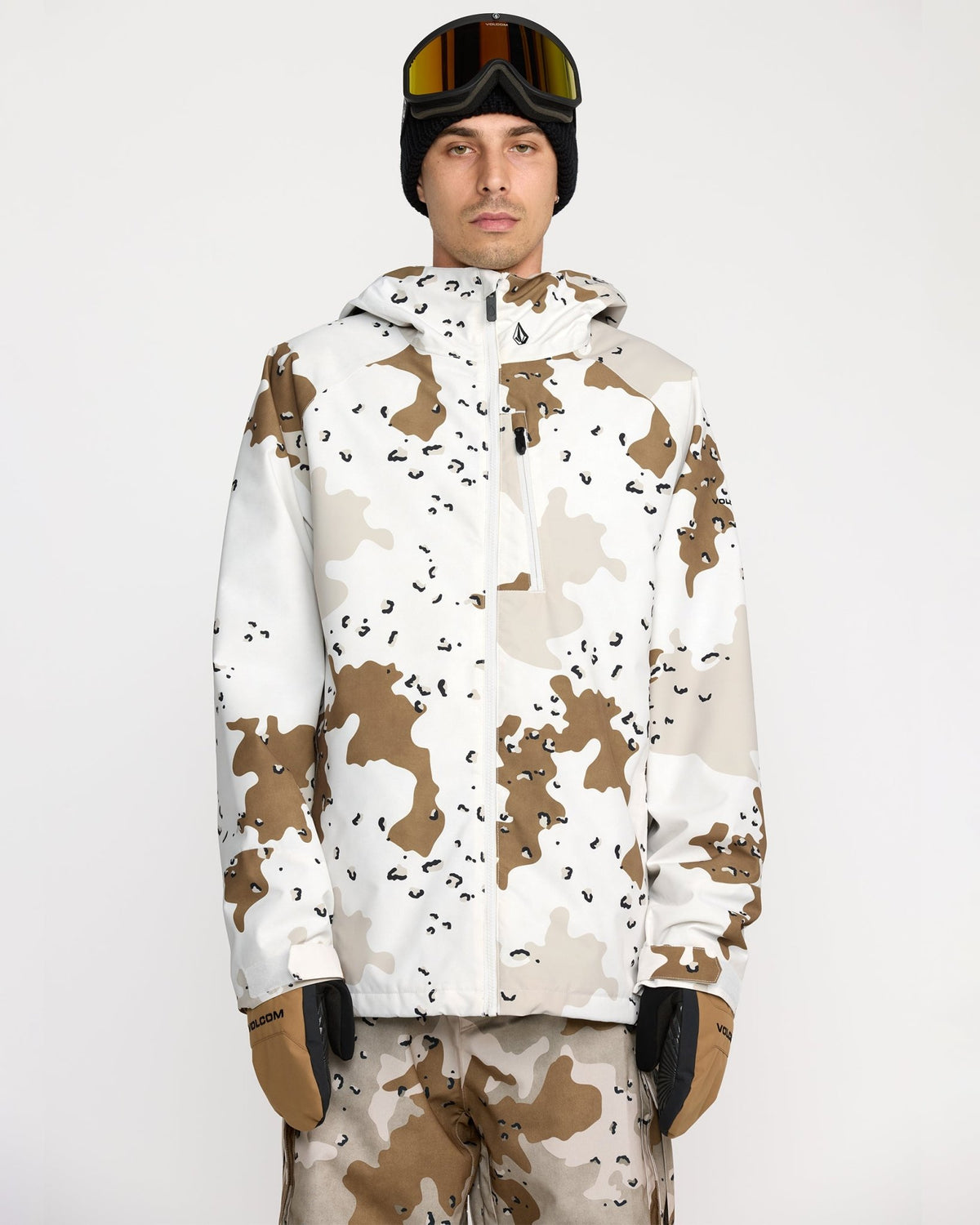 Volcom men's insulated snow jacket with hood, worn with matching pants and goggles