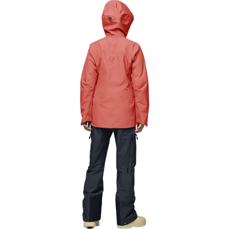 Norrona women's hooded Gore-Tex shell jacket shown from behind with dark pants