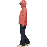 Women's hooded Gore-Tex ski jacket with chest zip pocket, paired with dark navy pants and boots.