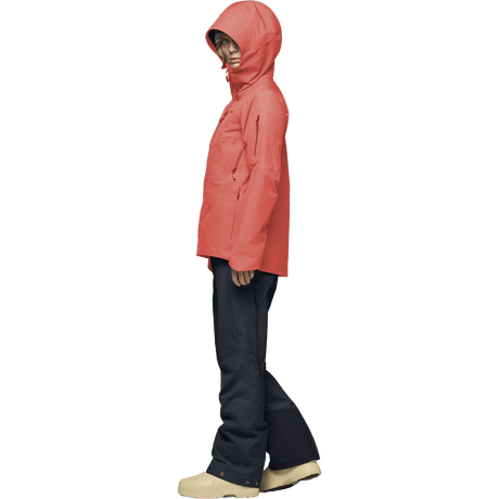 Women's hooded Gore-Tex ski jacket with chest zip pocket, paired with dark navy pants and boots.