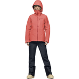 Women's hooded Gore-Tex ski jacket with zip pockets, paired with dark technical pants.