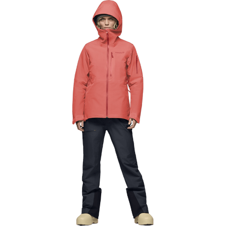 Women's hooded Gore-Tex ski jacket with zip pockets, paired with dark technical pants.