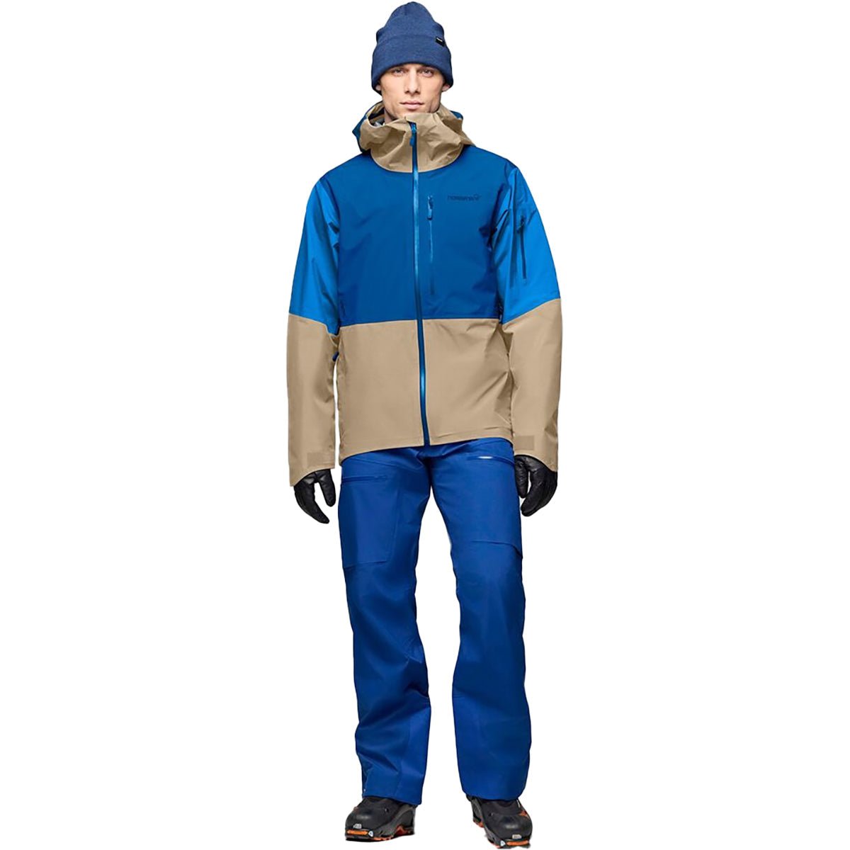 Men's technical ski jacket with colorblock design, hood, and waterproof construction worn with matching pants