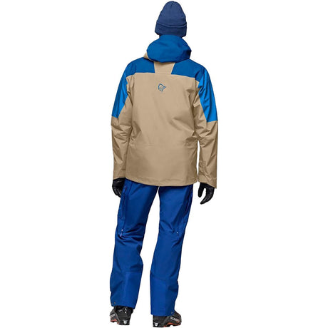 Norrona men's ski jacket shown from behind with hood up and matching snow pants