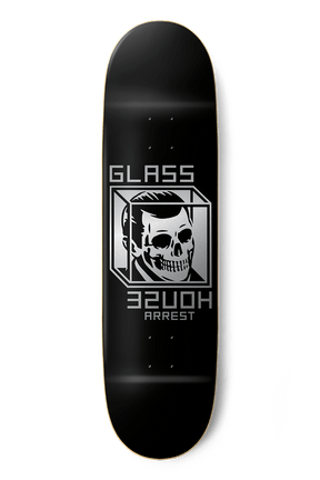 Black skateboard deck with silver skull graphic and Glass House Arrest text