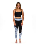 Black and blue floral print neoprene leggings with light blue waistband on female model
