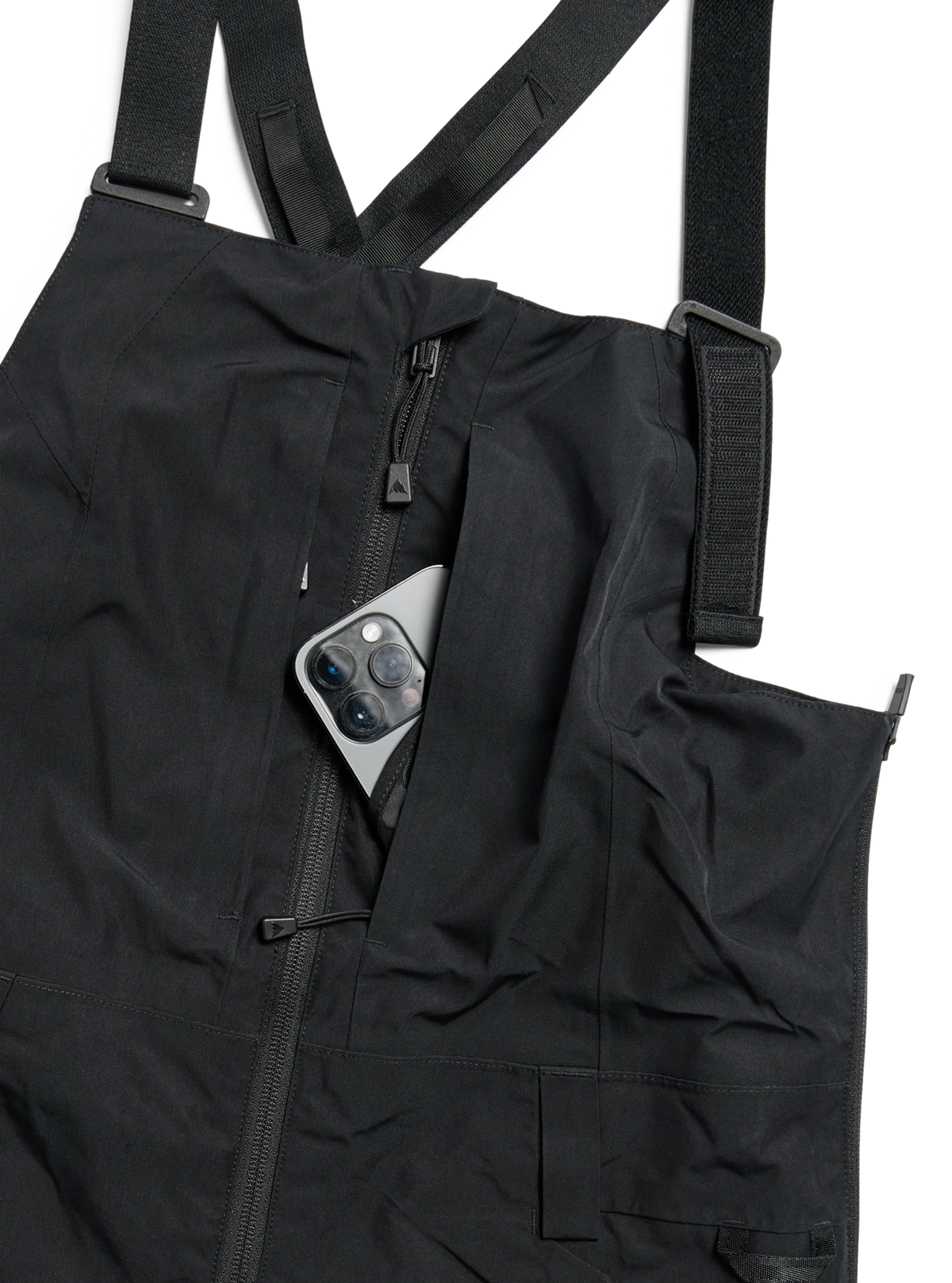 Women's bib snow pants with adjustable straps, zipper pocket, and phone storage detail