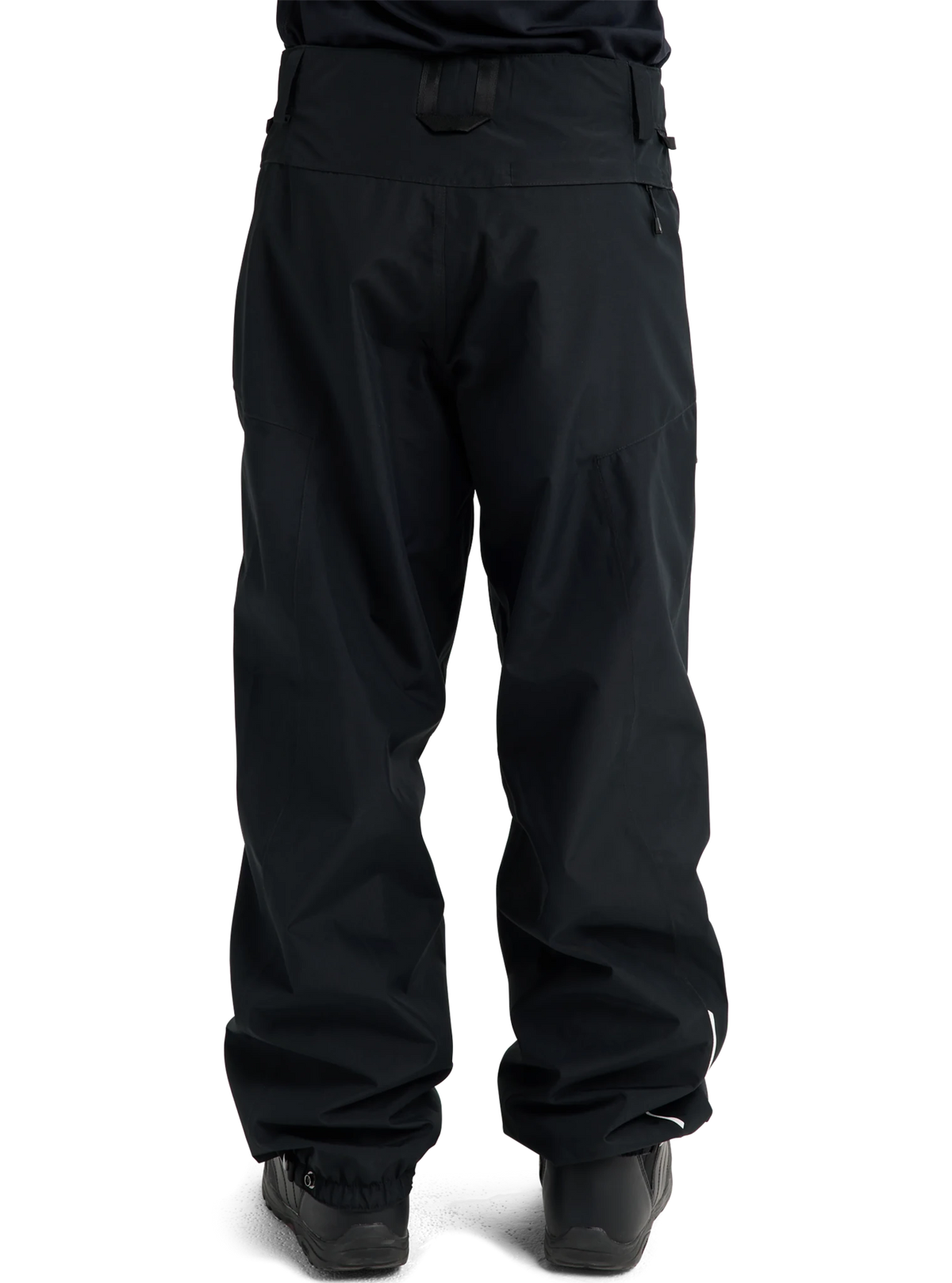 Burton women's relaxed fit snow pants shown from the back with ski boots