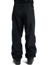 Burton women's relaxed fit snow pants shown from the back with ski boots