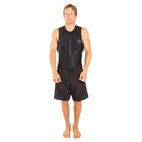 Man wearing black sleeveless zip-up impact vest and black board shorts, studio background