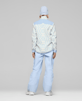 Women's Norrona fleece jacket with geometric pattern shown from back on model with matching pants
