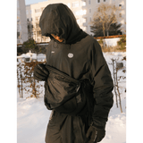 686 men's hooded pullover windbreaker with fanny pack worn outdoors in snow