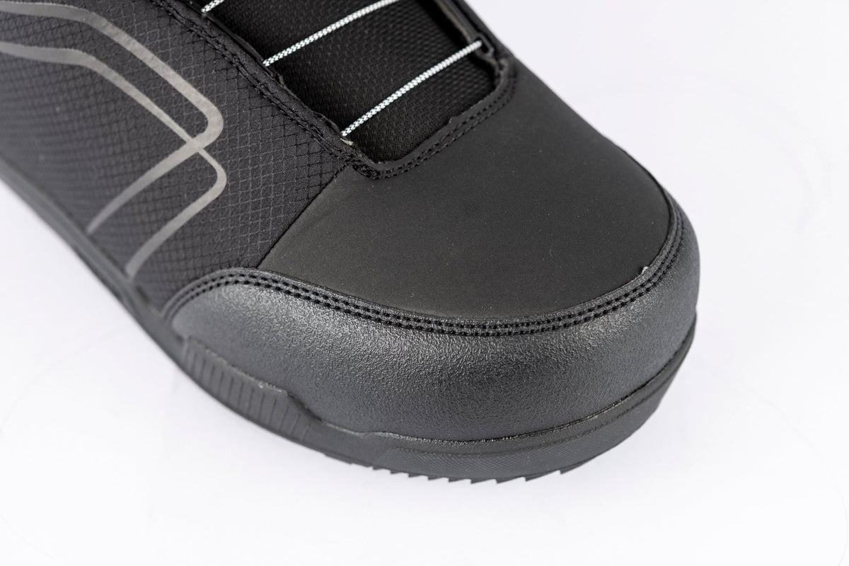 Close-up of a men's snowboard boot with BOA closure system and textured upper