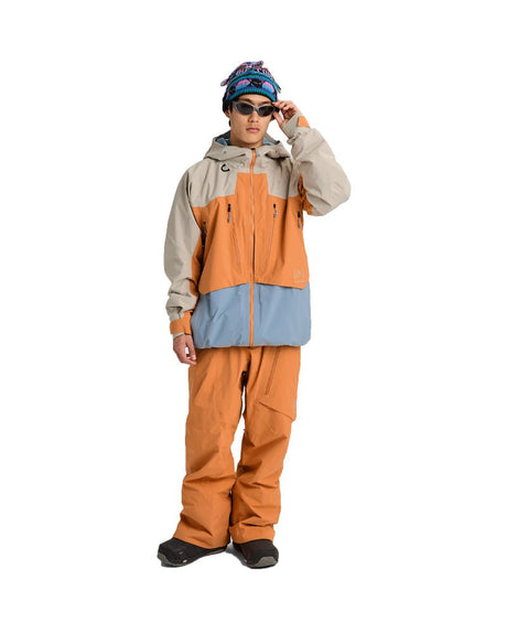 Burton AK Swash Gore-Tex insulated ski jacket shown in colorblock design on male model with goggles