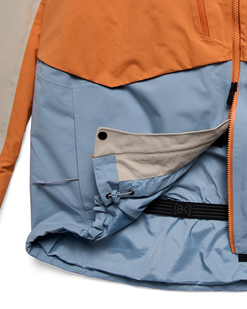 Burton AK Swash insulated jacket detail showing powder skirt, hem cinch, and pass clip
