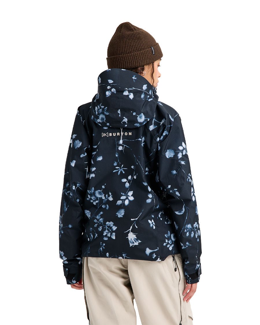 Burton women's Gore-Tex snowboard jacket with botanical floral print, shown from the back on a model