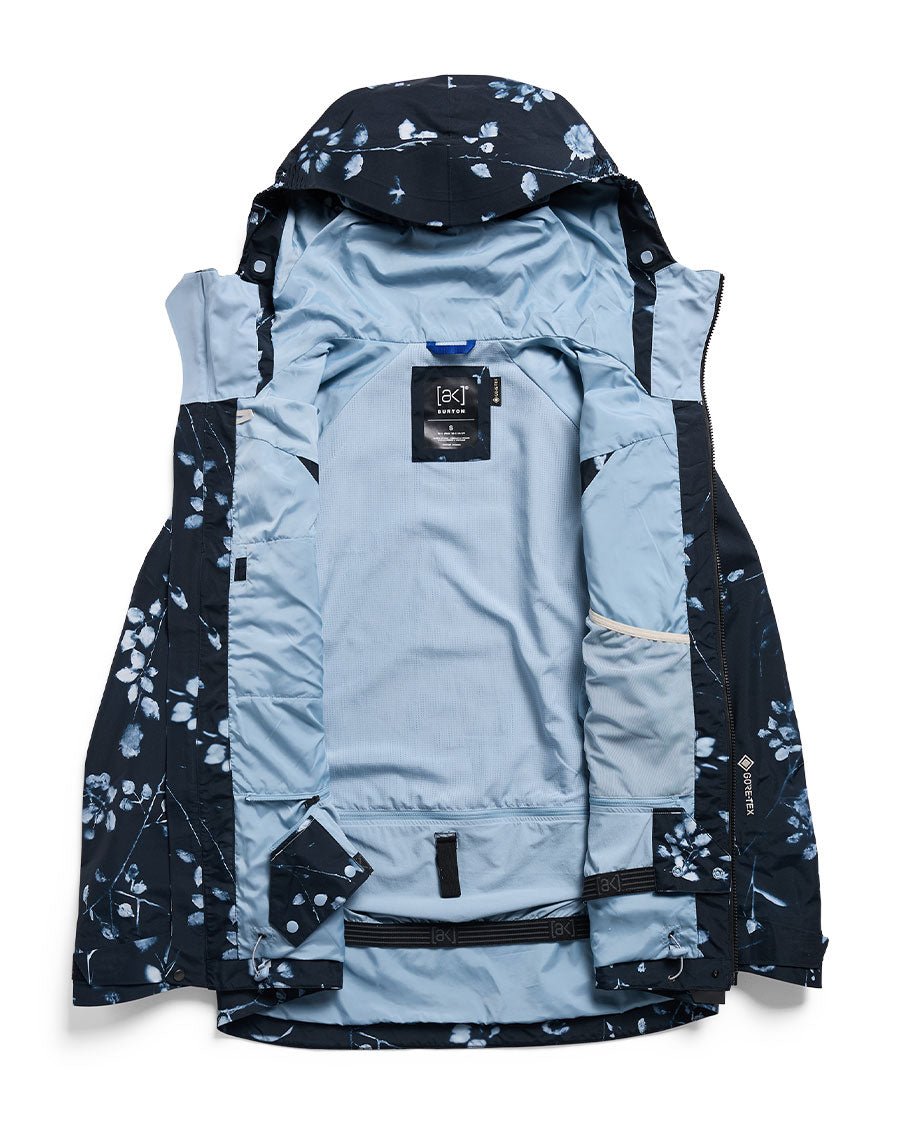 Burton women's Gore-Tex 2L snowboard jacket shown open displaying light blue interior lining and floral exterior