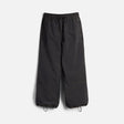 Wide-leg parachute pants with drawstring waist and ankle closures, orange contrast stitching details