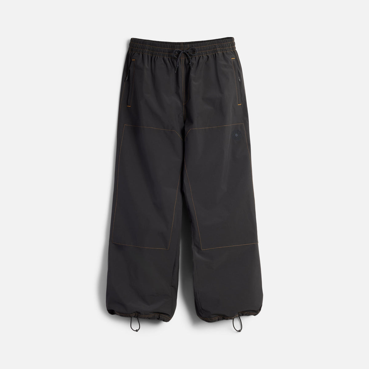 Wide-leg parachute pants with drawstring waist and ankle closures, orange contrast stitching details
