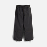 Wide-leg parachute pants with drawstring waist and ankle closures, orange contrast stitching details