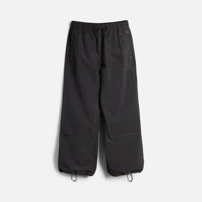 Wide-leg parachute pants with drawstring waist and ankle closures, orange contrast stitching details