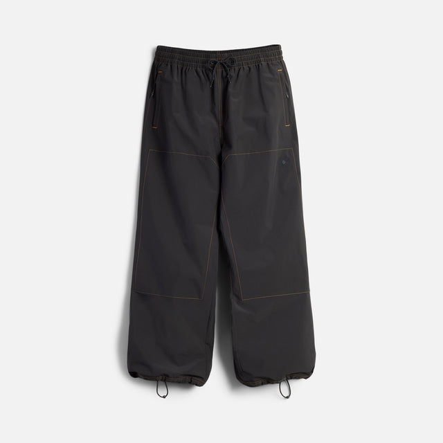 Wide-leg parachute pants with drawstring waist and ankle closures, orange contrast stitching details