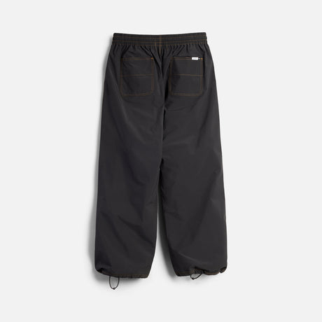 Wide-leg relaxed fit pants with elastic waistband, back patch pockets, and cinched ankles