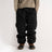 Relaxed fit cargo pants with large side pockets and elastic waistband, styled with boots.
