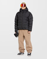 Men's quilted puffer hooded jacket with subtle seam detailing, worn with snow pants and goggles.