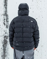 Men's quilted puffer jacket with hood, back view, shown in snowy outdoor setting