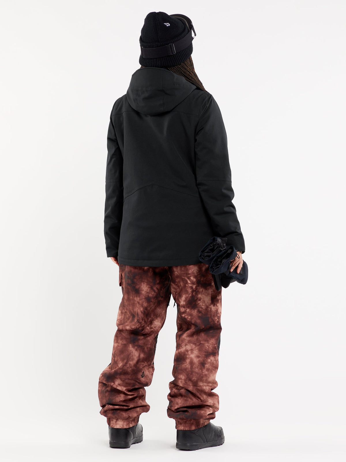 Volcom women's insulated snow jacket with hood shown from rear on model with snow pants