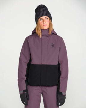 Volcom women's insulated snow jacket with two-tone colorblock design and hood, worn by model