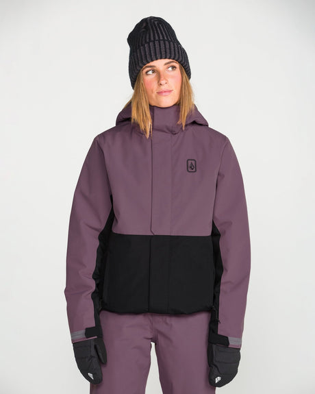 Volcom women's insulated snow jacket with two-tone colorblock design and hood, worn by model