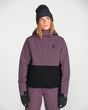 Volcom women's insulated snow jacket with two-tone colorblock design and hood, worn by model