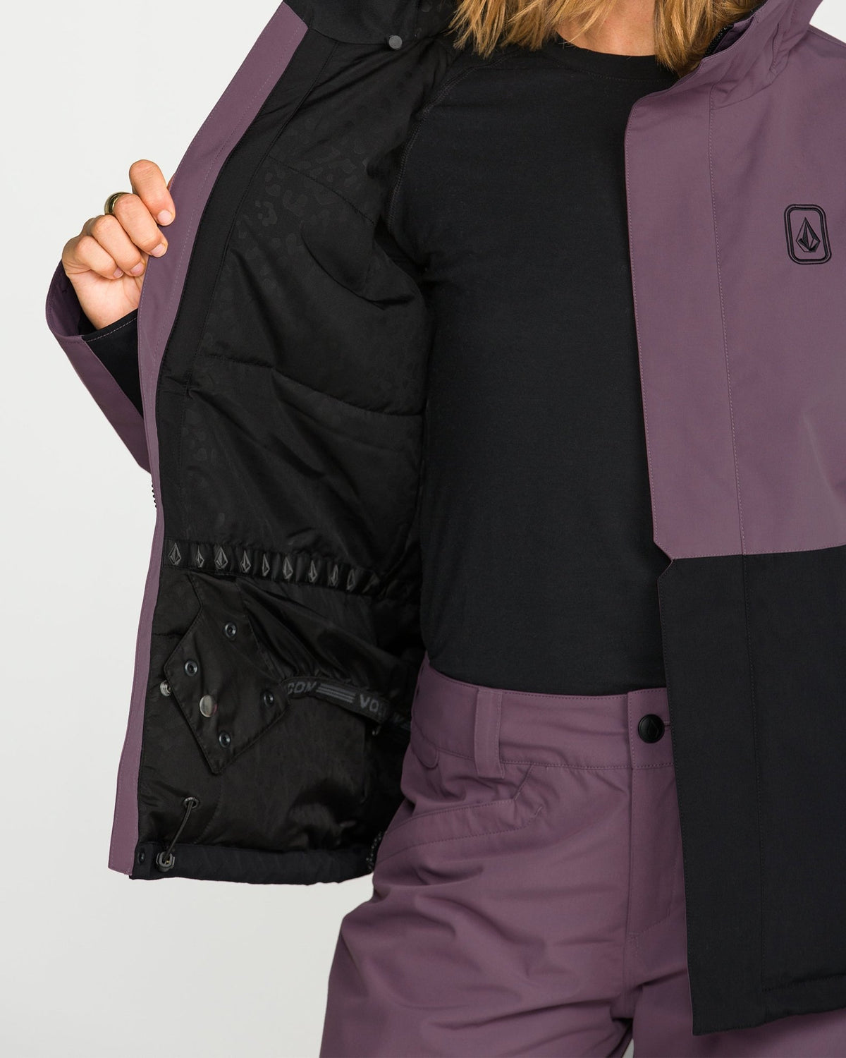 Volcom women's insulated snow jacket shown open revealing quilted black interior lining