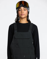 Volcom women's stretch bib overall with adjustable straps and chest pocket, modeled on figure