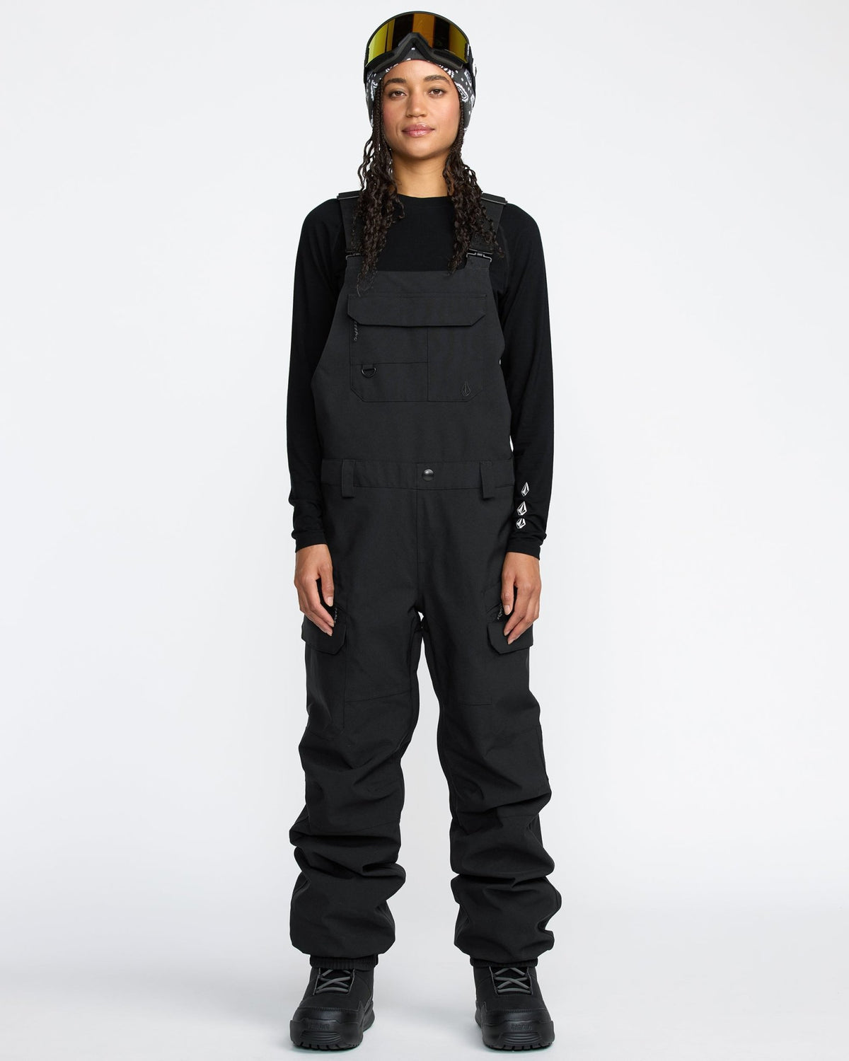 Women's snow bib overalls with cargo pockets, adjustable straps, and waterproof construction