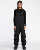Women's snow bib overalls with cargo pockets, adjustable straps, and waterproof construction