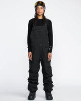 Women's snow bib overalls with cargo pockets, adjustable straps, and waterproof construction