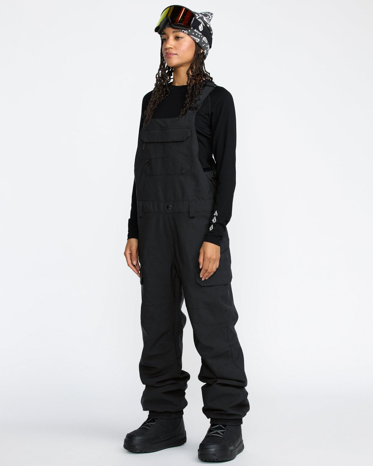 Women's snow bib overalls with cargo pockets, bib chest pocket, and wide-leg fit