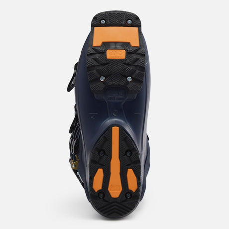 Bottom view of alpine ski boot sole showing orange grip pads and tread pattern